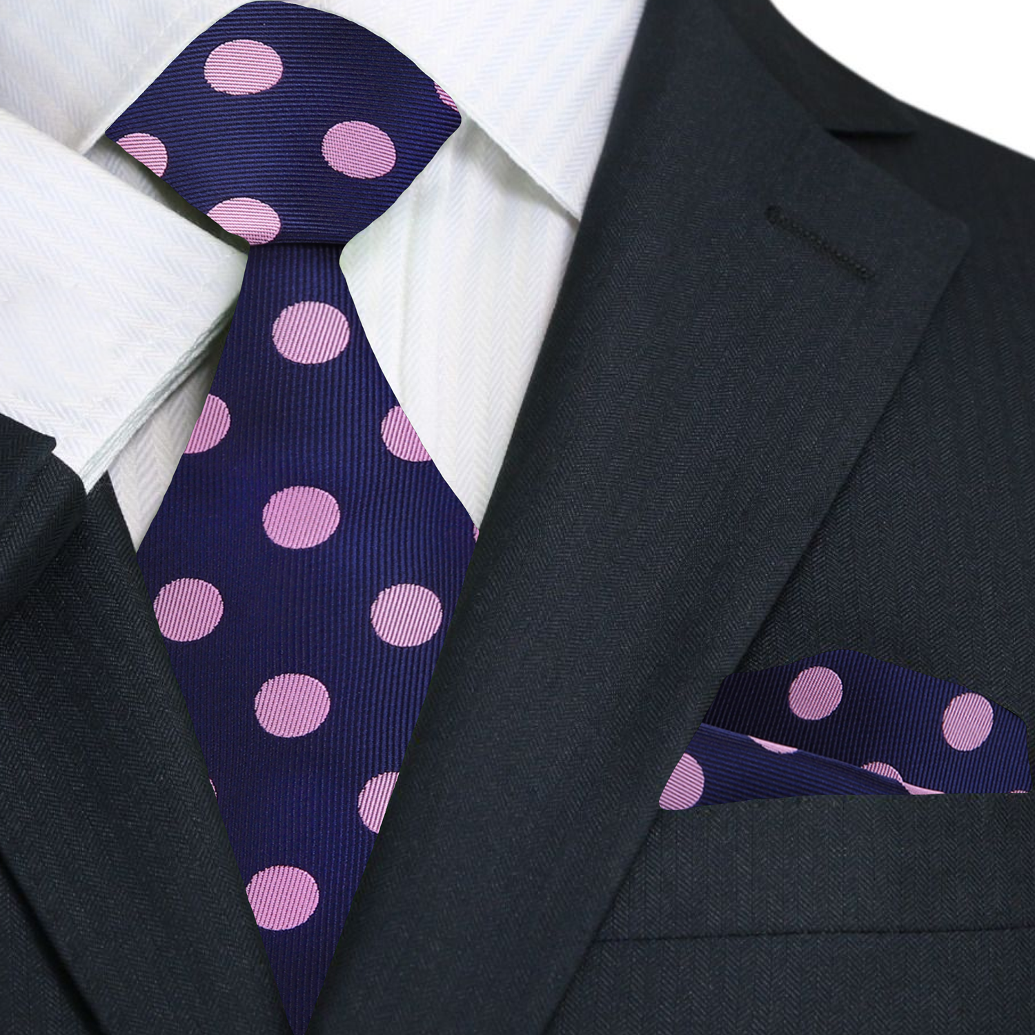 Navy blue tie with pink polka dots and matching pocket square on a suit.