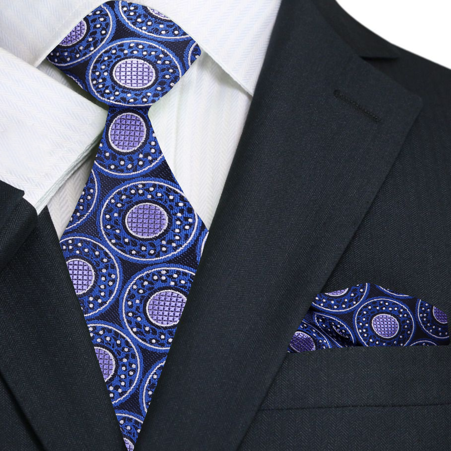 Navy suit with a blue and purple patterned tie and pocket square.