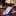 Rolled-up checkered tie on a wooden table with a blurred background