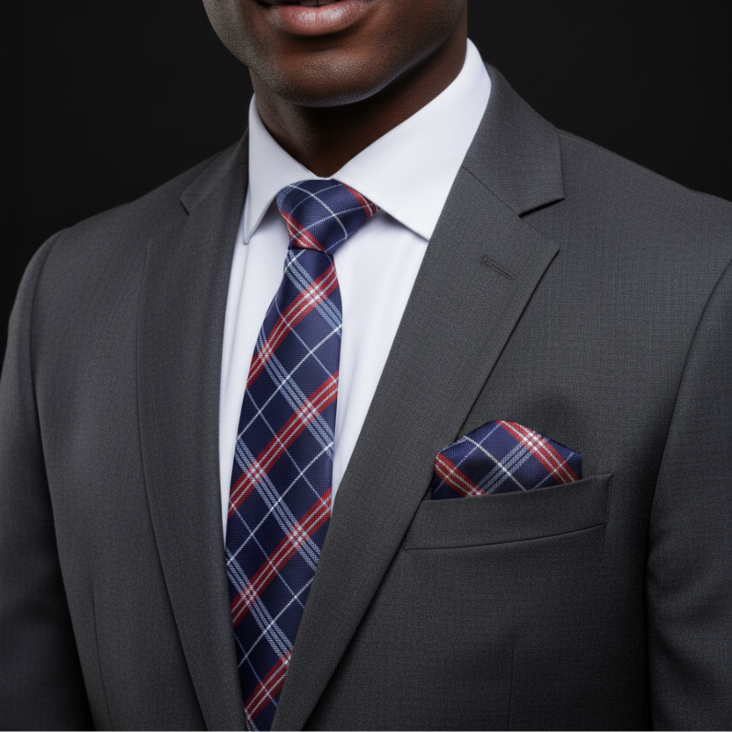 Man wearing blue and red plaid necktie and matching square