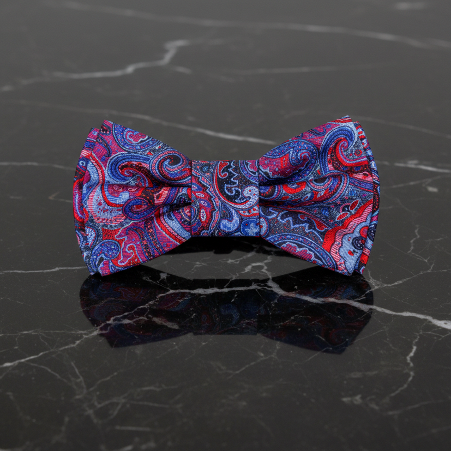 A detailed red and blue paisley bow tie