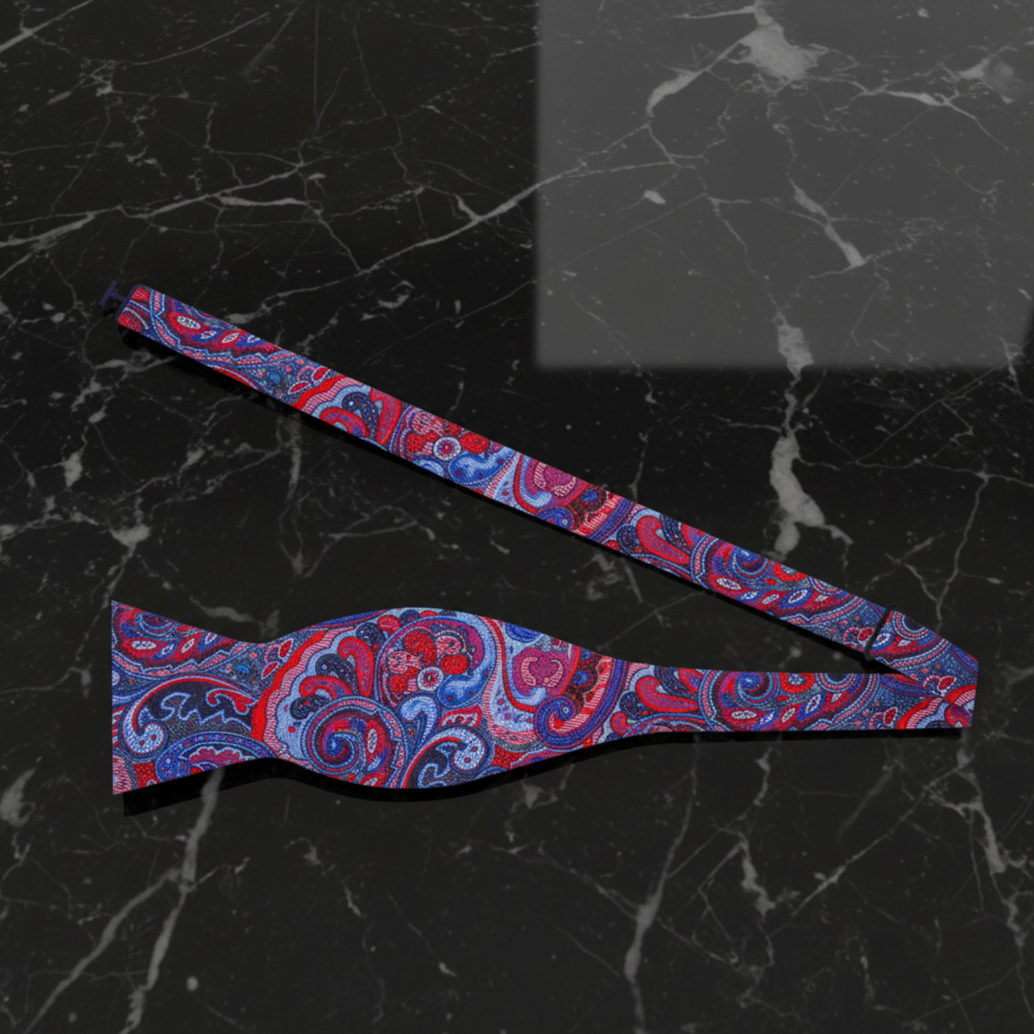 A detailed red and blue paisley bow tie self  tie