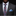 Man wearing a dark gray suit with a floral tie and blue pocket square on a black background