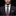Man wearing a black suit with a patterned tie and pocket square on a dark background