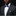 Man wearing a dark suit with a floral bow tie and pocket square against a black background