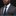 Man wearing a gray suit with a blue tie and pocket square on a black background