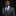 Man wearing a gray suit with a blue striped tie against a black background