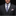 Man wearing a dark gray suit with a patterned tie and pocket square on a black background