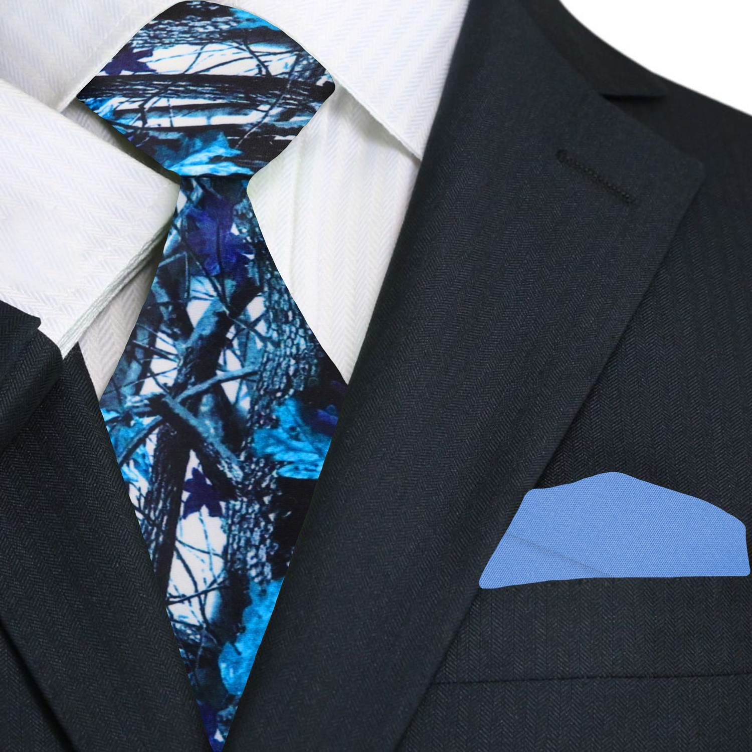 Black suit with a blue and black patterned tie and matching pocket square.