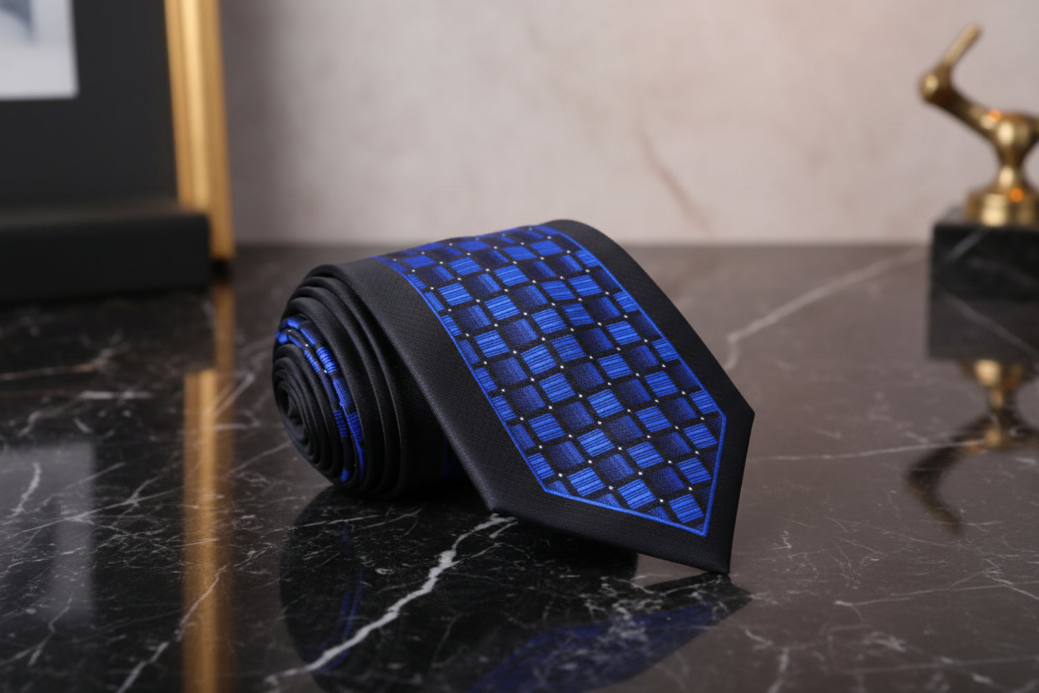 Black and blue patterned tie on a marble surface