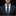 Man wearing a black suit with a blue tie and pocket square on a black background
