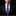 Man wearing a black suit with a blue tie and matching pocket square on a black background