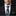 Man wearing a black suit with a floral tie and pocket square on a dark background