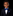 Young boy in a suit with a blue bow tie on a black background