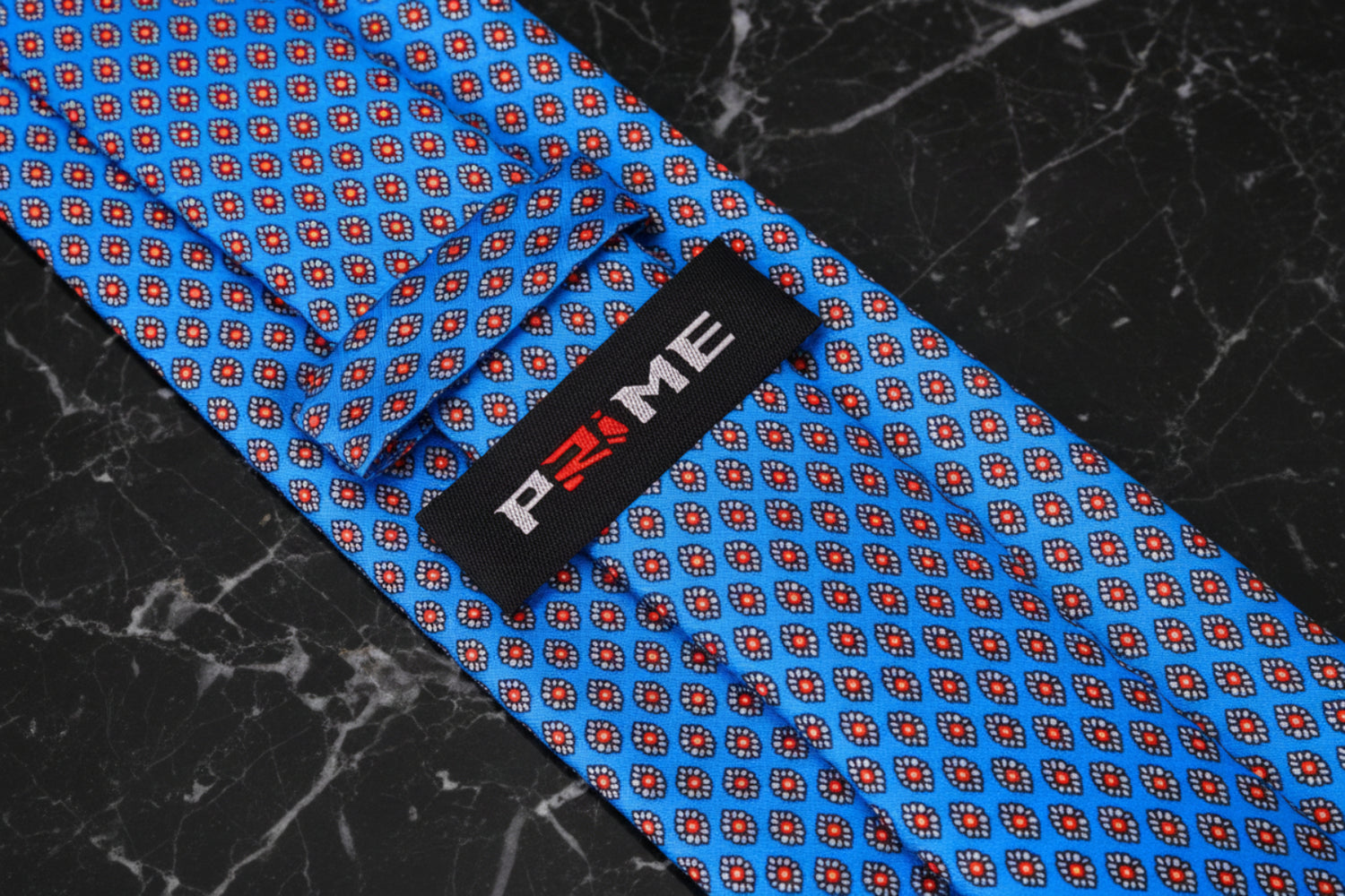 Blue with red and white small medallions necktie keep