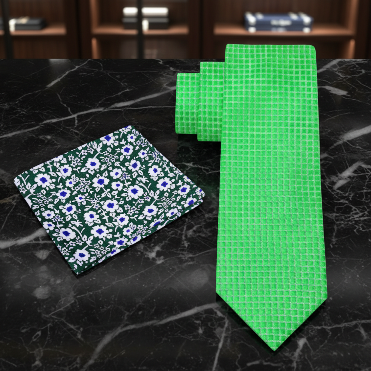 Green floral pocket square and green checkered tie on a dark background