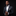 Man in a black suit with a bow tie against a black background