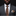 Man wearing a gray suit with a patterned tie and pocket square on a black background