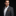 Man wearing grey suit with brown and gold geometric pocket square