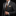 Man wearing a gray suit with a patterned tie and pocket square on a black background