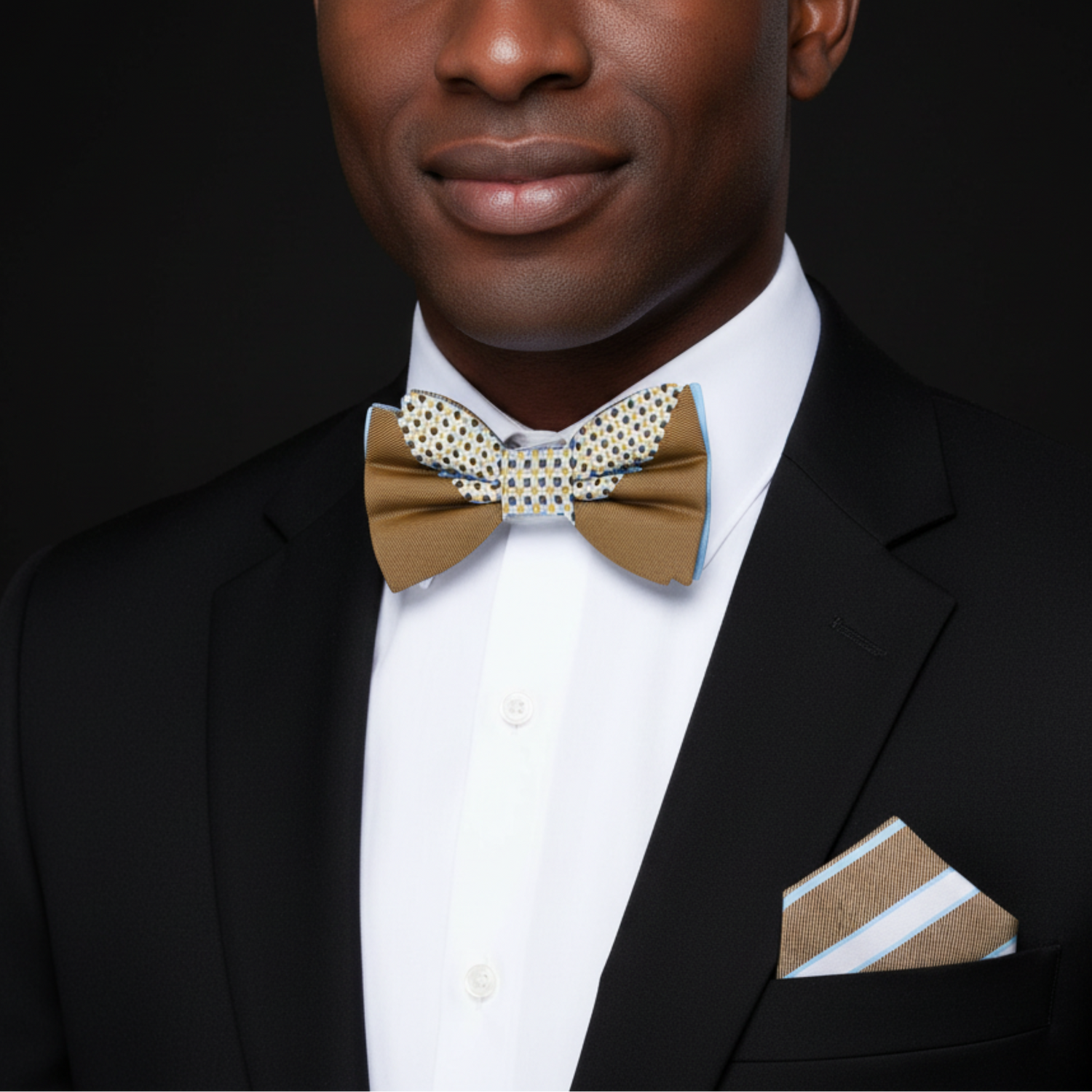Man wearing a black suit with a brown bow tie and matching pocket square on a black background