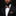 Man wearing a black suit with a patterned bow tie and pocket square on a dark background