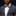 Man wearing a gray suit with a patterned bow tie and pocket square on a black background