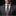Man wearing a gray suit with a patterned tie and pocket square against a black background