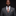 Man wearing a gray suit with an orange tie against a black background