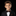 Young boy in a formal suit with a bow tie against a black background