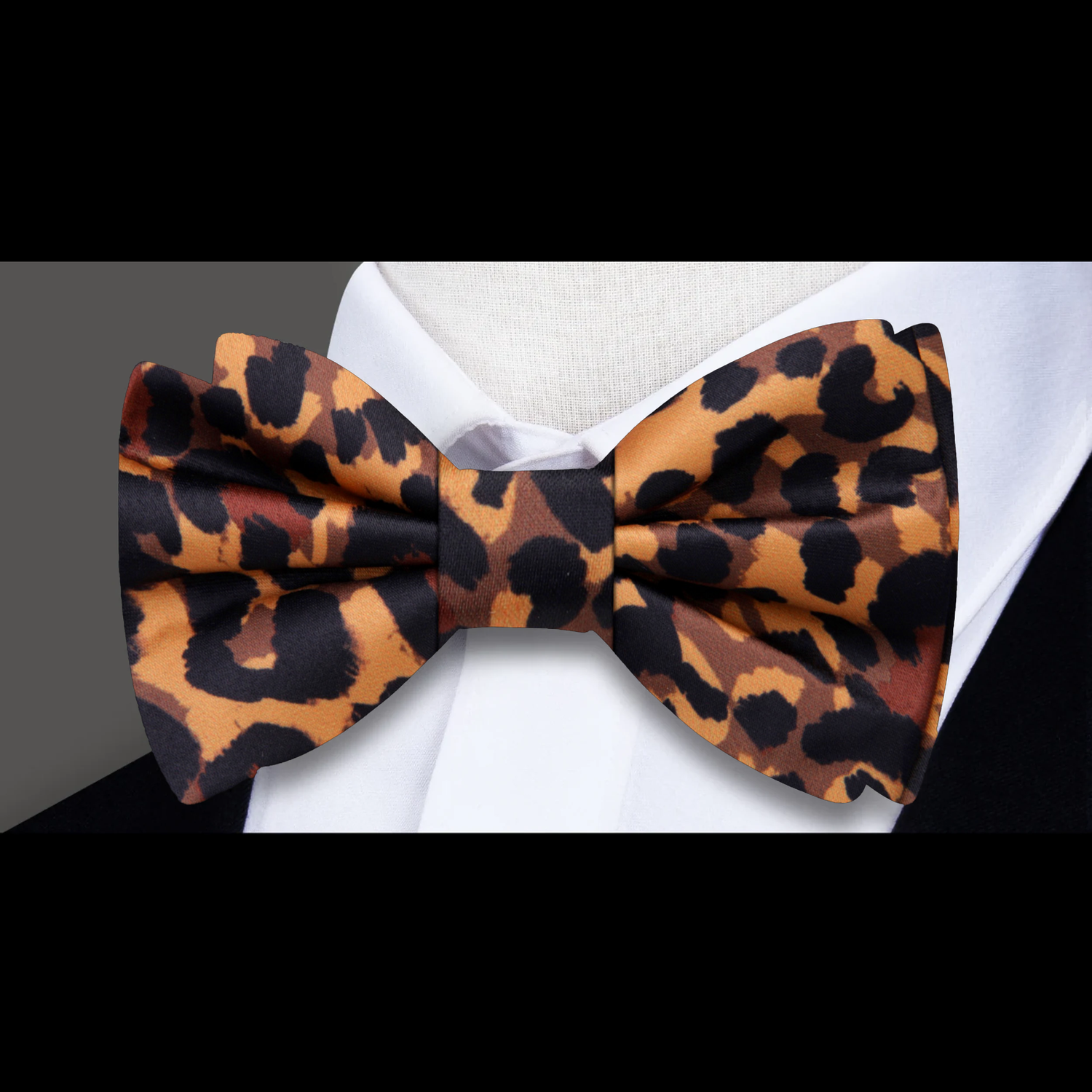 Leopard print bow tie on a white shirt with a gray background