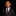 Young boy in a formal black suit with a red tie against a black background