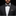 Man wearing a dark gray suit with a patterned bow tie and pocket square on a black background