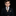Young boy in a formal suit with a tie against a black background