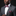 Man wearing a gray suit with a red and white bow tie and pocket square on a black background