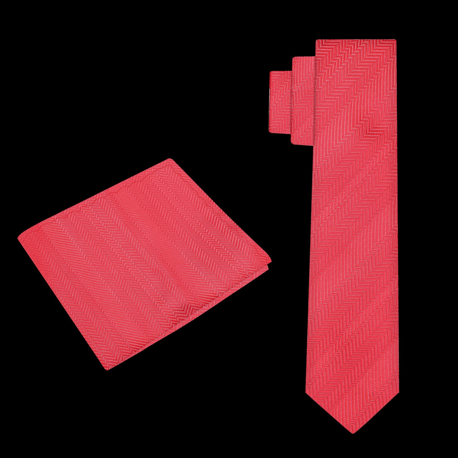 Red tie and matching pocket square on a black background
