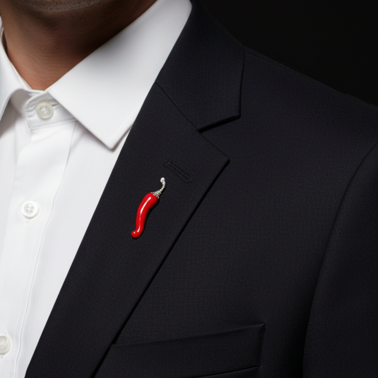 Red chili pepper brooch on a black suit jacket