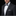 Man wearing a black tuxedo with a gray bow tie and pocket square on a black background