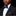 Man wearing a black suit with a white shirt and blue polka dot bow tie and pocket square.