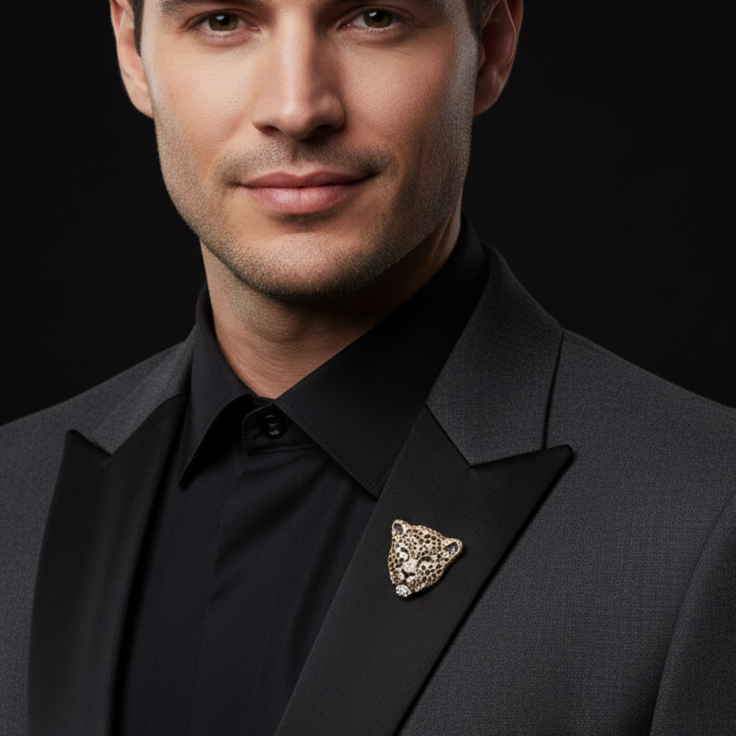 Man wearing a black suit with a leopard brooch on a black background