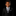 Young boy in a black suit with a polka dot tie on a black background
