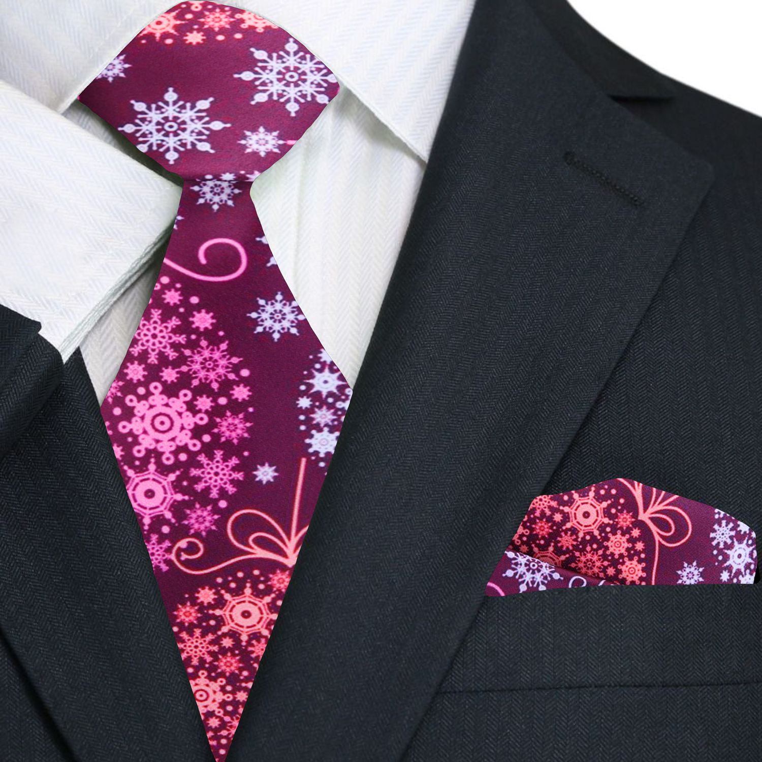 Black suit with a pink and purple patterned tie and pocket square.