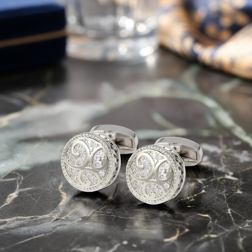 a pair of chrome cufflinks that are circular