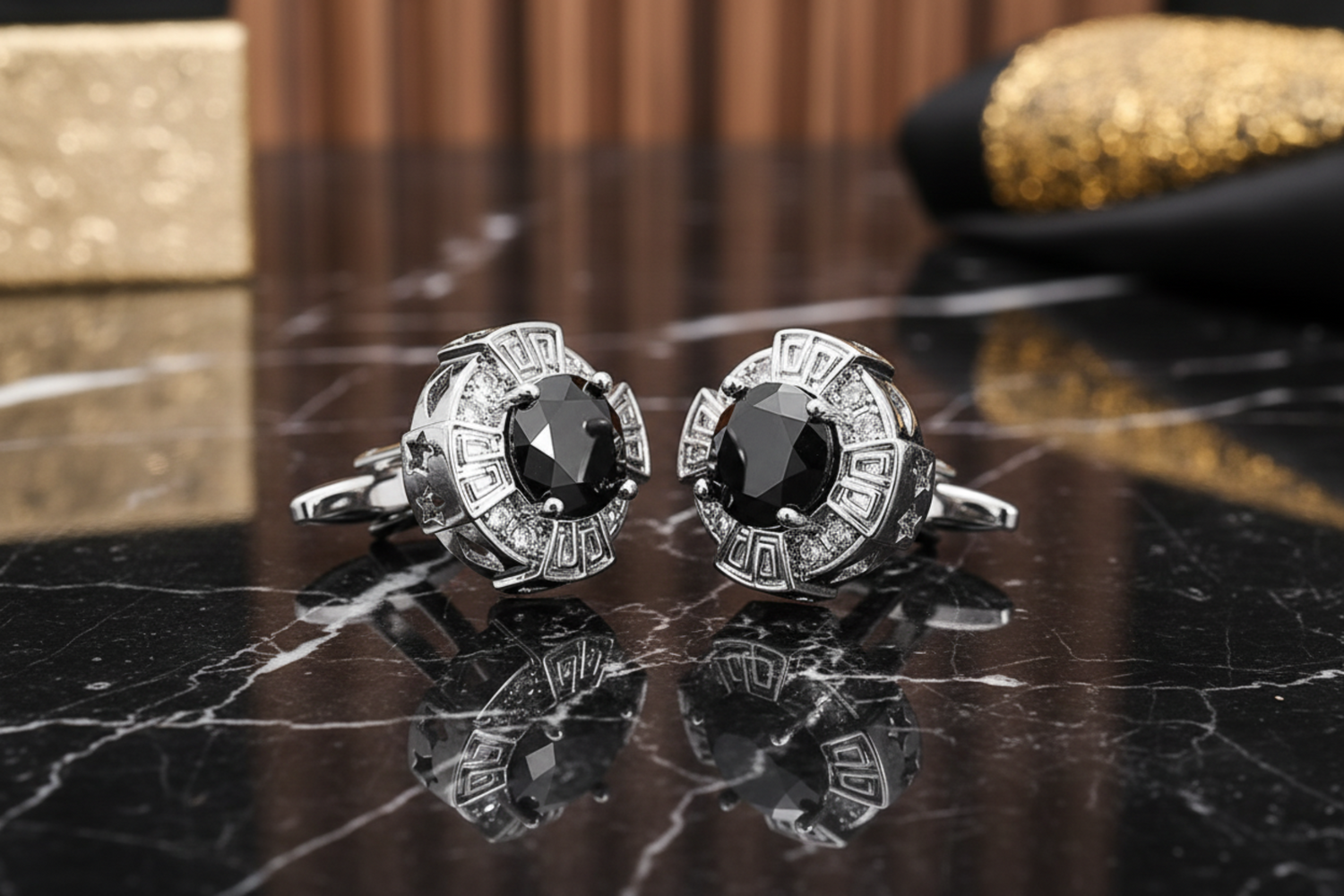 A pair of gold-colored circular cufflinks with red and clear stones set within.