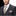 Man wearing a gray suit with a patterned tie and pocket square on a white background