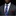 Man wearing a gray suit with a purple paisley tie and red pocket square on a black background