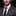 Man wearing a gray suit with a floral lapel pin on a black background