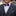 Man wearing a gray suit with a purple bow tie and matching pocket square.