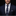 Man wearing a navy suit with a patterned tie and pocket square on a black background