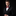Man wearing a black suit with a red bow tie on a black background